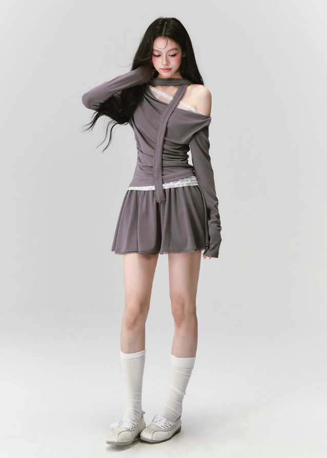 The Migratory Lace Sonata Set drapes the body in Fragileheart’s signature melancholy elegance. A soft ashen knit wraps asymmetrically over lace, revealing just enough fragility beneath structure. Paired with a flowing skirt trimmed in translucent lace, it moves like twilight — graceful, introspective, and quietly magnetic.