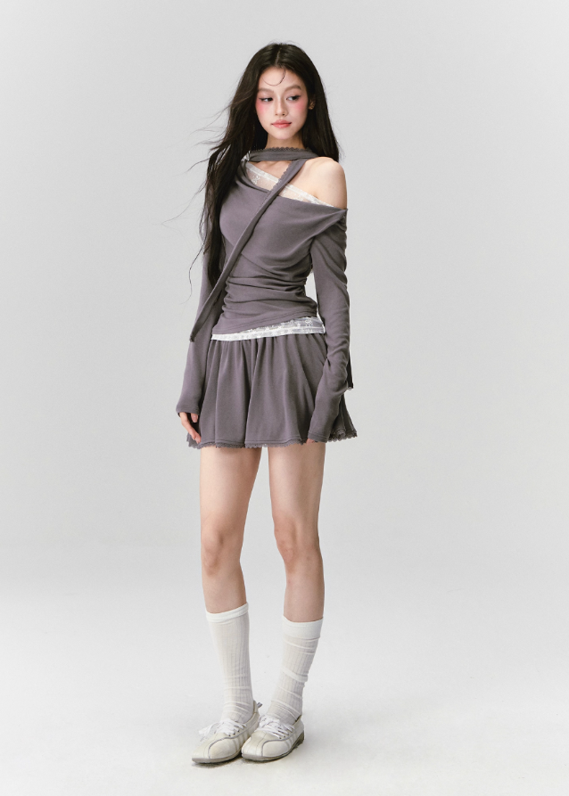 The Migratory Lace Sonata Set drapes the body in Fragileheart’s signature melancholy elegance. A soft ashen knit wraps asymmetrically over lace, revealing just enough fragility beneath structure. Paired with a flowing skirt trimmed in translucent lace, it moves like twilight — graceful, introspective, and quietly magnetic.