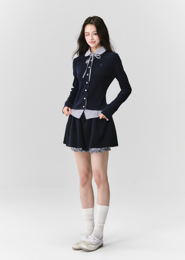 The Moon Academy Knit Set reimagines classic school-girl charm through Fragileheart’s lens of quiet luxury. Featuring a fitted knit blouse with a gingham collar and bow detail, paired with a matching pleated skirt, this ensemble balances intellectual poise and youthful softness. Perfect for autumn transitions and city walks that whisper elegance, not effort.