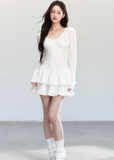 Fragileheart knit dress, ballet style outfit, ivory ruffle one-piece, luxury Korean fashion, quiet luxury womenswear, pastel noir aesthetic, elegant autumn dress, V-neck knit outfit, pre-autumn K-fashion, romantic feminine style, tiered ruffle skirt, soft Korean fashion, delicate white dress, graceful knit one-piece