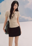 ivory polo knit top, slim fit knit tee, short sleeve knit women, korean fashion top, ribbed polo shirt women, minimalist knit top, feminine casual top, lightweight knitwear, everyday elegant outfit, soft knit blouse, parisian style top, fitted knit shirt, breathable summer knit, versatile basic top, refined casual wear, modern feminine clothing, chic simple top, aesthetic fashion knit, clean line top women, wardrobe essential knit