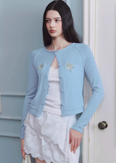 knit cardigan women, floral cardigan top, raglan sleeve cardigan, korean fashion knit, lightweight cardigan women, spring knitwear, feminine cardigan top, soft knit blouse, pastel cardigan women, breathable knit top, casual elegant outfit, parisian style clothing, aesthetic fashion knit, modern feminine clothing, versatile layering top, chic everyday cardigan, delicate detail knit, cropped cardigan women, soft luxury knitwear, casual spring outfit