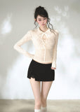 Ivory argyle knit cardigan with pointed collar and keyhole neckline