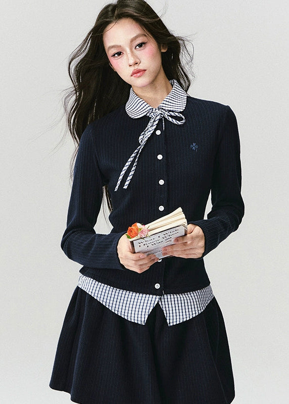 The Moon Academy Knit Set reimagines classic school-girl charm through Fragileheart’s lens of quiet luxury. Featuring a fitted knit blouse with a gingham collar and bow detail, paired with a matching pleated skirt, this ensemble balances intellectual poise and youthful softness. Perfect for autumn transitions and city walks that whisper elegance, not effort.