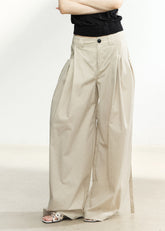 Beige high-waisted wide-leg trousers with side pleats