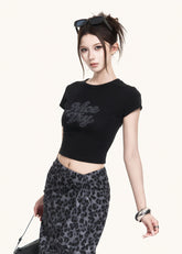 Fitted black short-sleeve tee styled with a leopard skirt