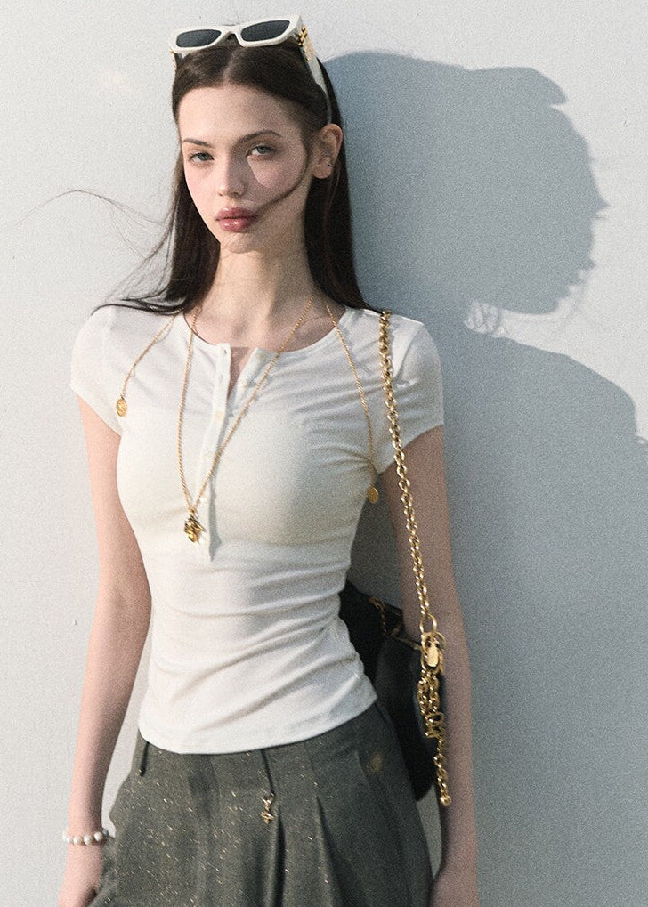 White fitted button-neck tee styled with wide-leg trousers