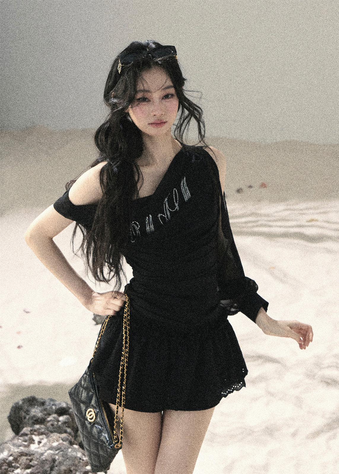 Black off-shoulder mesh top with ruched fit and sheer long sleeve