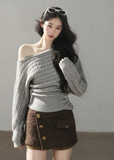 Grey cable knit off-shoulder sweater with decorative side buttons