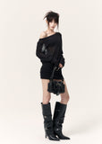Front view of a fitted black mini dress with a sheer neckline and wide waist belt