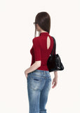 Slim red top styled with blue flare jeans