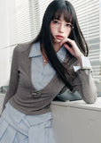 A quiet evolution of the preppy muse — the Blue Prelude Layered Shirt blends striped academia with Fragileheart’s signature delicate poise. The faux two-piece design layers a mist-grey knit over a powder-blue shirt, finished with a minimalist floral accent at the chest. A study in balance, it redefines the modern school-girl aesthetic with luxury subtlety.