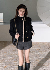 Black wool blend jacket with contrasting cream trim and gold buttons