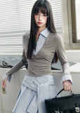 A quiet evolution of the preppy muse — the Blue Prelude Layered Shirt blends striped academia with Fragileheart’s signature delicate poise. The faux two-piece design layers a mist-grey knit over a powder-blue shirt, finished with a minimalist floral accent at the chest. A study in balance, it redefines the modern school-girl aesthetic with luxury subtlety.