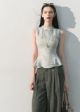 Pale blue sleeveless peplum top with ruffle hem