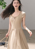Beige tie-detail maxi dress with flowing skirt