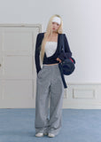 Model wearing gray plaid wide-leg pants with vintage lace waist detailing