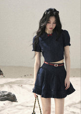 Short-sleeve crop top styled with pleated mini skirt