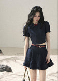 Short-sleeve crop top styled with pleated mini skirt