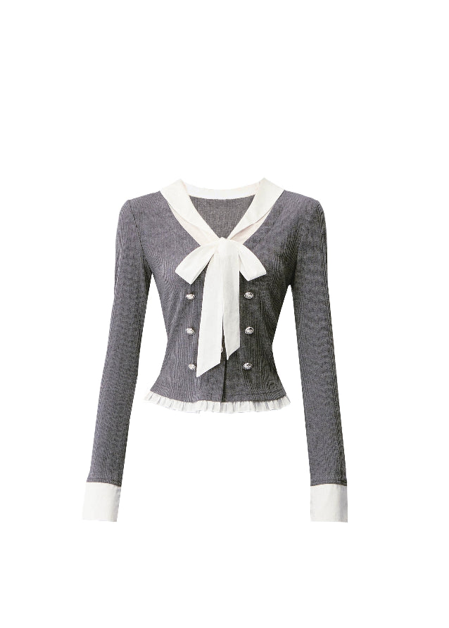 A soft rebellion in knit form — this double-breasted faux two-piece top blends vintage academia with K-fashion sensuality. The ivory bow and pleated trim contrast against charcoal grey, creating a refined silhouette that flatters with quiet confidence. Perfect for 2025 fall looks that balance grace and edge.