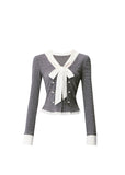 A soft rebellion in knit form — this double-breasted faux two-piece top blends vintage academia with K-fashion sensuality. The ivory bow and pleated trim contrast against charcoal grey, creating a refined silhouette that flatters with quiet confidence. Perfect for 2025 fall looks that balance grace and edge.