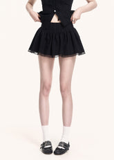 Edgy black two-piece outfit with flared mini skirt
