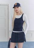 Model wearing a navy and white faux-layered top with a drawstring mini skirt