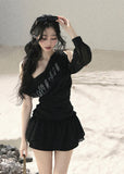 Black off-shoulder mesh top with ruched fit and sheer long sleeve