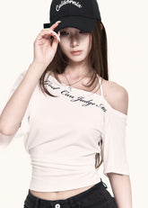 White asymmetric crop tee styled with black shorts
