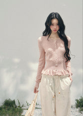 AOMALM pearl knit cardigan, French romantic cropped sweater, feminine spring knit top, Korean elegant cardigan women, pearl button knitwear, soft blush cropped cardigan, quiet luxury womens knit, ruffle hem spring sweater, romantic Korean French aesthetic clothing, delicate feminine knit top, waist defining cropped cardigan, lightweight spring knitwear women, refined pearl detail sweater, elegant pastel cardigan outfit, soft romantic womenswear knit, luxury feminine spring fashion, blush pink knit cardigan,