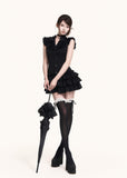 Black romantic mini dress styled with a parasol