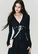 Fragileheart knit skirt set, black pleated two-piece, luxury Korean fashion, elegant autumn outfit, quiet luxury womenswear, pastel noir aesthetic, V-neck cardigan set, modern feminine K-fashion, minimalist ribbed knit, poetic fashion 2025, romantic fall outfit, delicate Korean style, sophisticated knitwear set, graceful pleated skirt look