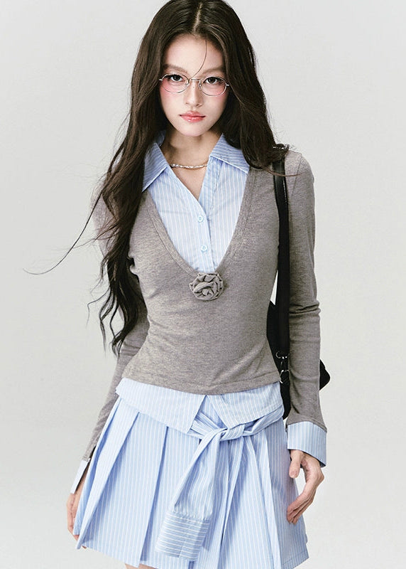 A quiet evolution of the preppy muse — the Blue Prelude Layered Shirt blends striped academia with Fragileheart’s signature delicate poise. The faux two-piece design layers a mist-grey knit over a powder-blue shirt, finished with a minimalist floral accent at the chest. A study in balance, it redefines the modern school-girl aesthetic with luxury subtlety.