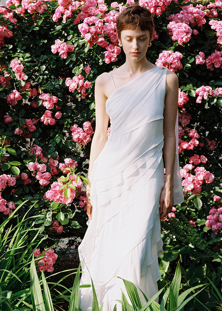 White one-shoulder maxi dress with cascading ruffle detail