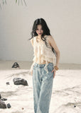 Ivory layered ruffle sleeveless top with cascading chiffon details