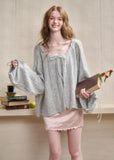 Lightweight fuzzy cardigan worn off the shoulder