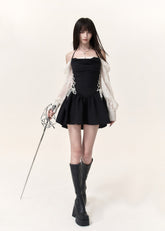 Black corset mini dress with ivory lace puff sleeves and flared skirt