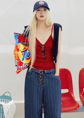 Red ribbed knit camisole styled with a navy cardigan and striped denim bottoms
