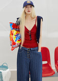 Red ribbed knit camisole styled with a navy cardigan and striped denim bottoms