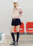 Navy cotton shorts with a contrasting light waistband and small white front buttons