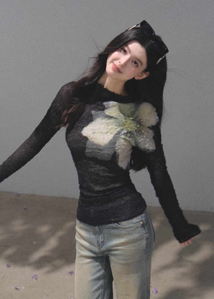 Black textured long-sleeve top with a green and ivory botanical print