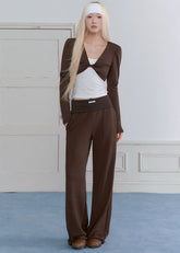Model wearing a blue-gray ballet-inspired long-sleeve top and pants set