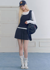 Model wearing a navy and white faux-layered top with a drawstring mini skirt