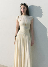 Cream slim-fit knit maxi dress with flowing skirt