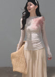 Ivory fitted top featuring a soft pink floral pattern and crinkled texture