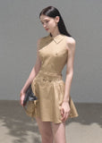 Model wearing a khaki cape-overlay mini dress with a matching belt