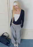 Sky-blue long-sleeve knit top with a twisted wrap front