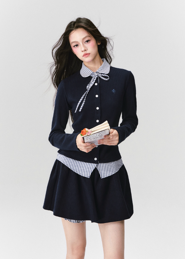 The Moon Academy Knit Set reimagines classic school-girl charm through Fragileheart’s lens of quiet luxury. Featuring a fitted knit blouse with a gingham collar and bow detail, paired with a matching pleated skirt, this ensemble balances intellectual poise and youthful softness. Perfect for autumn transitions and city walks that whisper elegance, not effort.