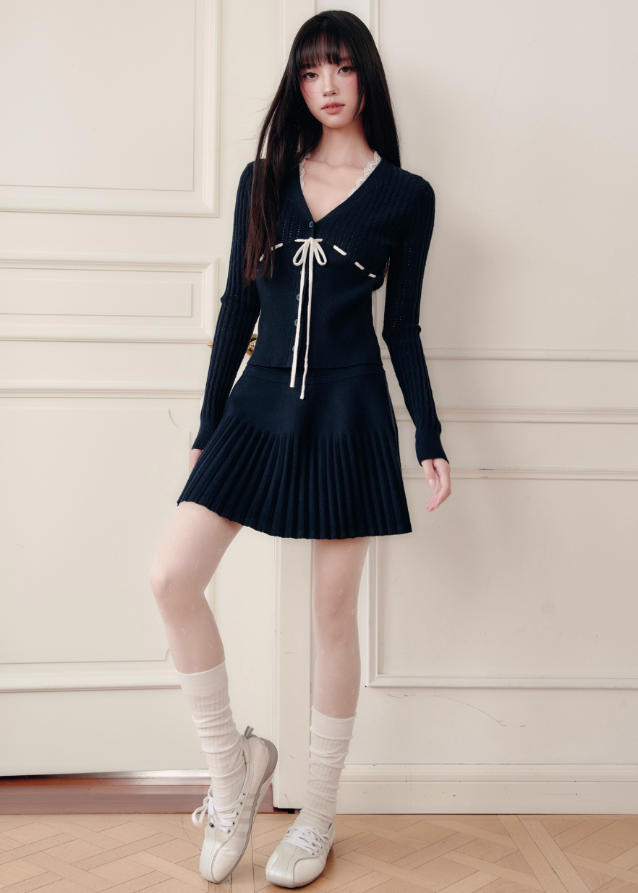 Fragileheart knit skirt set, black pleated two-piece, luxury Korean fashion, elegant autumn outfit, quiet luxury womenswear, pastel noir aesthetic, V-neck cardigan set, modern feminine K-fashion, minimalist ribbed knit, poetic fashion 2025, romantic fall outfit, delicate Korean style, sophisticated knitwear set, graceful pleated skirt look
