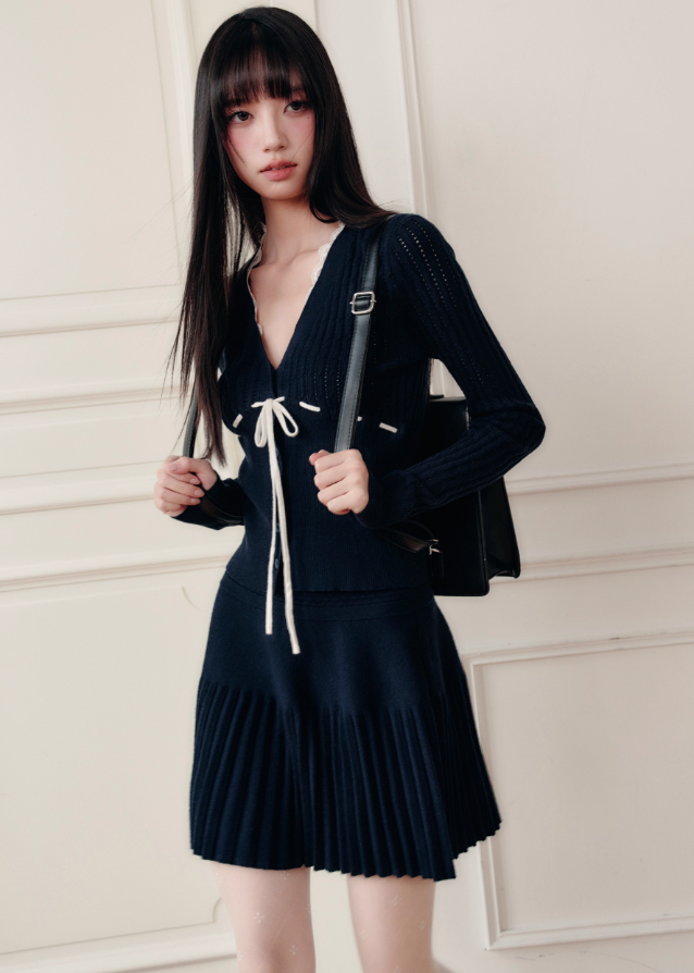 Fragileheart knit skirt set, black pleated two-piece, luxury Korean fashion, elegant autumn outfit, quiet luxury womenswear, pastel noir aesthetic, V-neck cardigan set, modern feminine K-fashion, minimalist ribbed knit, poetic fashion 2025, romantic fall outfit, delicate Korean style, sophisticated knitwear set, graceful pleated skirt look
